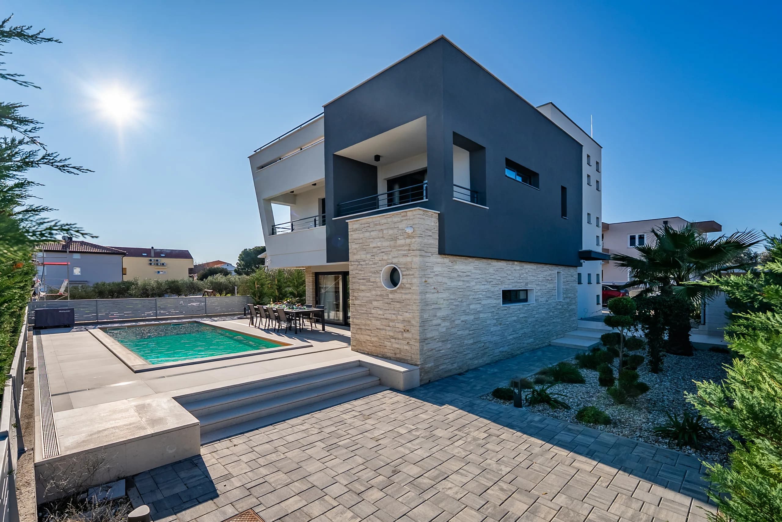 Villa exterior with garden and palm trees